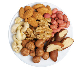 Set of nuts on a white plate, isolation