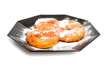 plate with home bakes apple fritter over white background