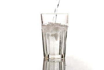 glass of mineral water with ice isolated on white