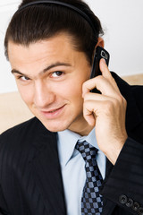 Young businessman holding a mobile phone