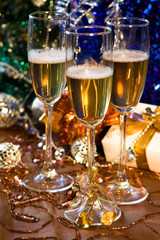 Glasses of champagne with gold ribbon gifts