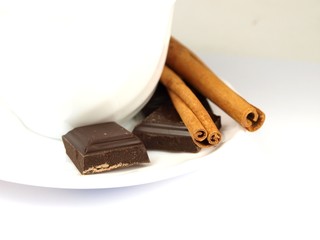 Coffees cup with bars of chocolate and cinnamon