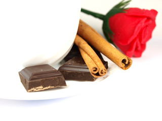 Coffees cup with bars of chocolate,red rose and cinnamon