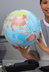 Close-up of an asian businesswoman holding terrestrial globe