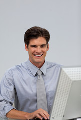 Cheerful businessman working at a computer