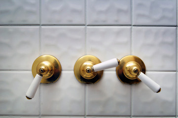 Three golden shower valve handles
