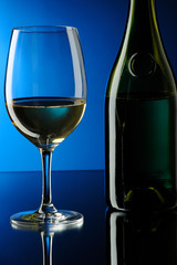 Glass and bottle of white wine.