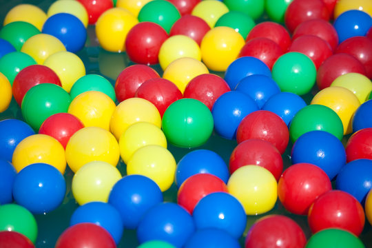 Multi-coloured balls float on water