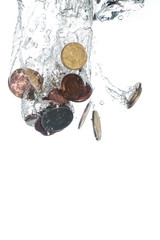 Coins falling into clear water