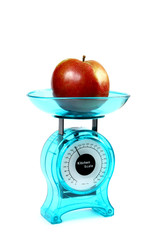 apple on a kitchen scale - diet concept