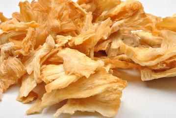 natural dried organic pineapple and a white background