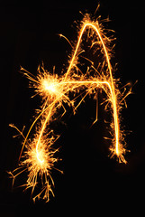 Letter A made of sparklers isolated on black
