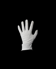 A white gloved hand isolated on black background