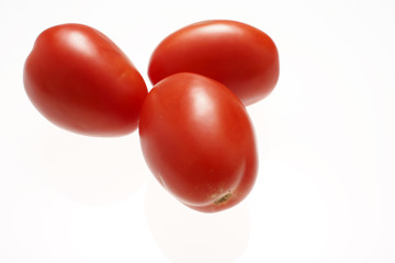 Fresh roma tomatoes isolated on white.