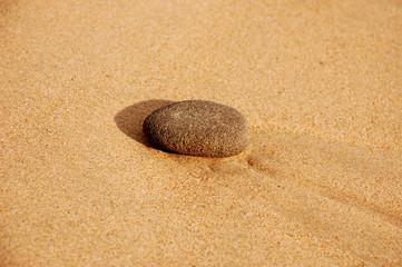 Fototapeta na wymiar Stone in sand