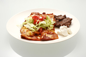 Plate of enchiladas and refried beans