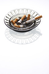 A smoldering cigarette in an ashtray.