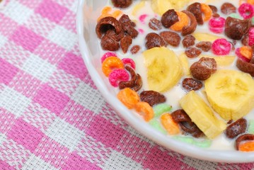 Healthy cereal topped with fruit and raisins