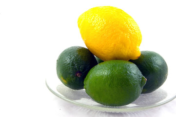 One Lemon and 3 Limes on a Clear Plate