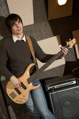 electro guitar player near ampifier. focus on. pouch of jeans