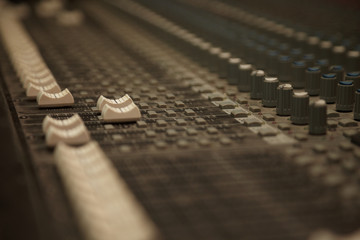 faders of dusty sound mixer. two faders in focus