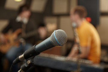 microphone. guitar player and keyboarder in out of focus