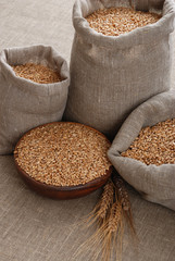 Grain of the wheat in bags and a bowl