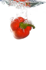 A paprika falling into clear water