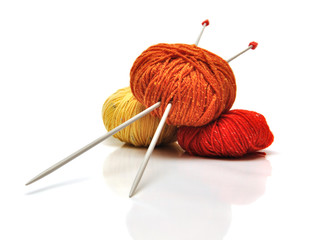 colored clews and knitting needles