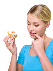 woman holding sweet cake and looking on it