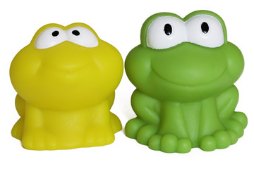 toy rubber frogs on white background