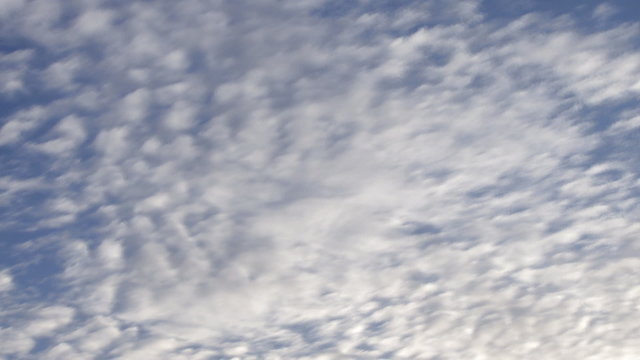 Time lapse clouds rolling in  blue sky
