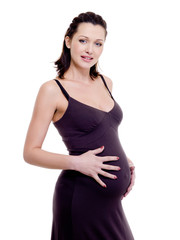 happy attractive pregnant woman touching her tummy