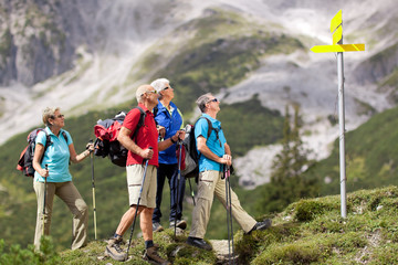 hikers looking at guidepost