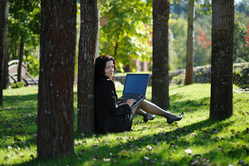 Young lady with a notebook in a park