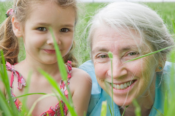 Girl and her grandmother in long grass