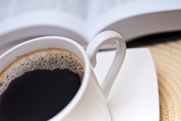 cup of coffee and opened book