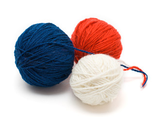 Three coil of yarn in red, blue and white