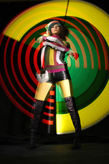 Fashion girl in dance on colorful light background