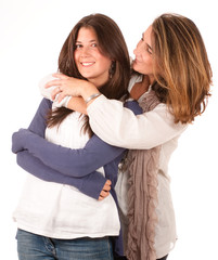 Mother cuddling her teen daughter