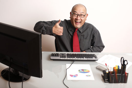 A businessman giving a thumbs up.