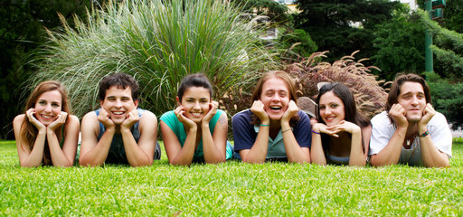 happy group of friends smiling outdoors in a park