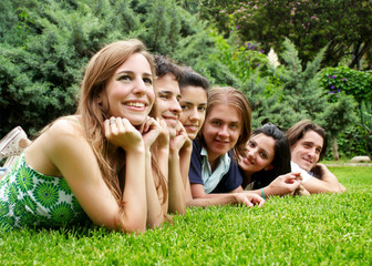 Fototapeta premium happy group of friends smiling outdoors in a park