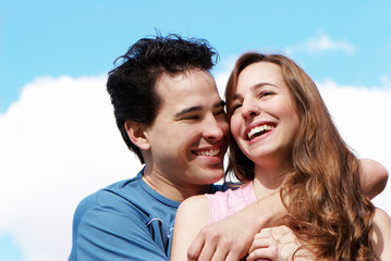 Happy young couple against the sky