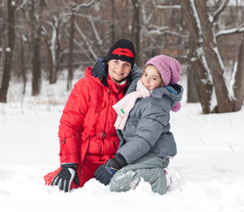 Fototapeta na wymiar Mother with her daughter outside in snow