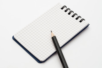 notebook with black pencil