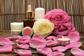 Burning the candle on the background of natural cosmetics - obrazy, fototapety, plakaty