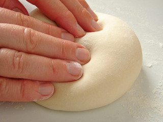 hands knead the dough