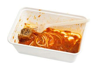 Leftover meatball spaghetti in a disposable container isolated