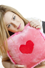 portrait of woman holding a pillow with heart
